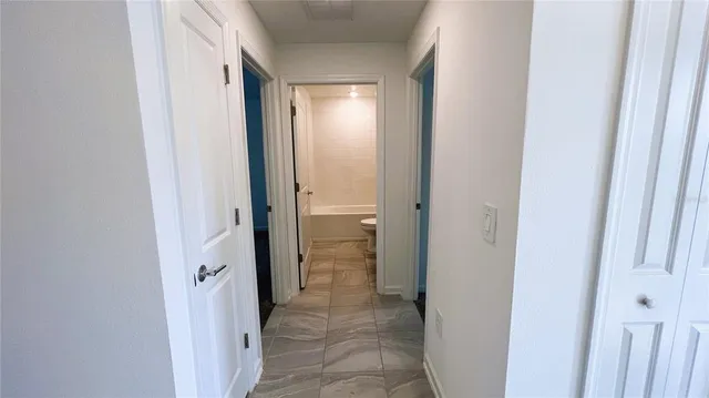 a view of a bathroom from a hallway