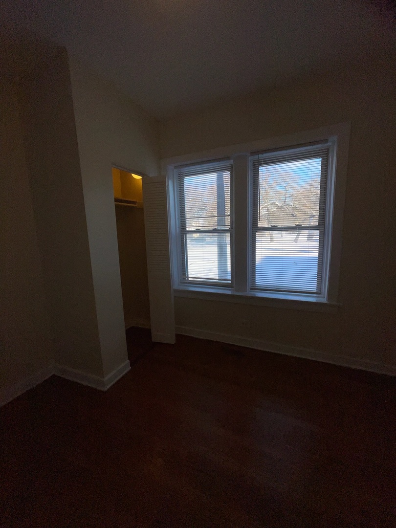 714 West 80th Street, Unit 1 Chicago, IL 60620 - Photo 4 of 10 a view of an empty room with wooden floor and a window