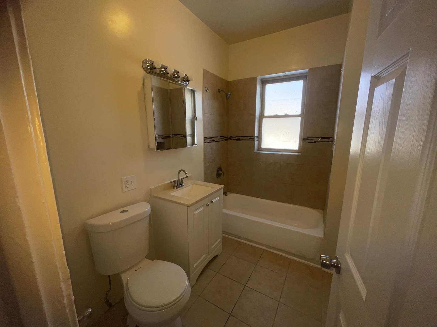 714 West 80th Street, Unit 1 Chicago, IL 60620 - Photo 6 of 10 a bathroom with a toilet a sink and bathtub
