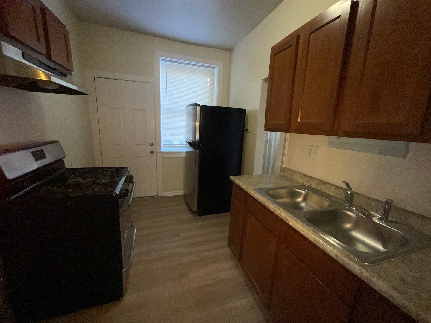 714 West 80th Street, Unit 1 Chicago, IL 60620 - Photo 7 of 10 a kitchen with a sink and a refrigerator