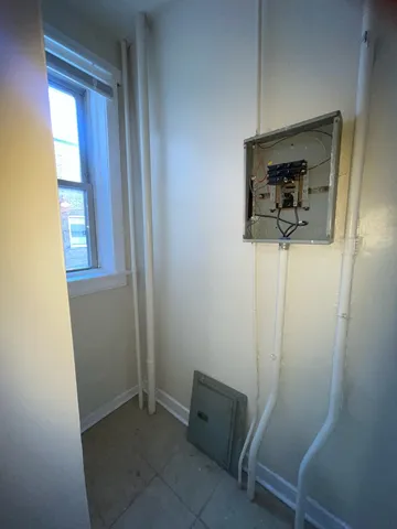 a view of hallway with mirror and a window