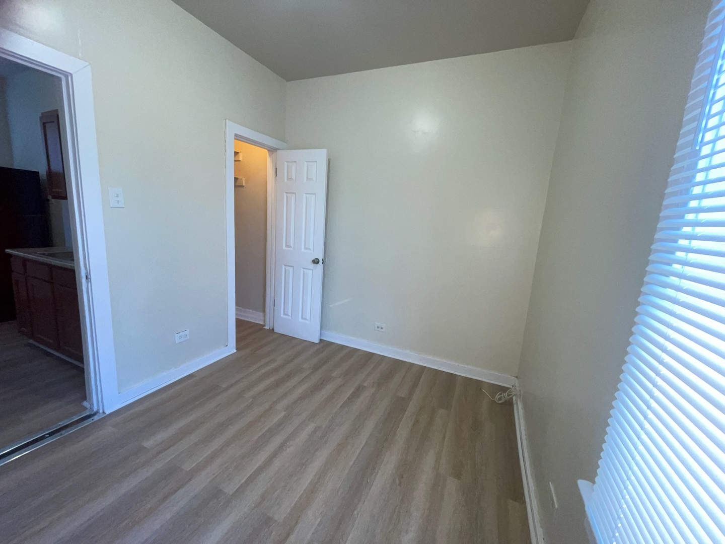 714 West 80th Street, Unit 1 Chicago, IL 60620 - Photo 10 of 10 a view of an empty room with wooden floor and a window