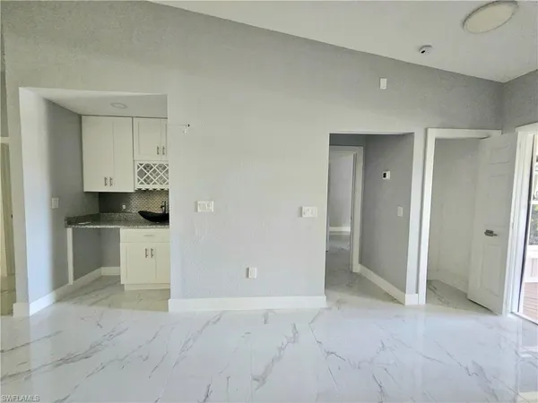 a view of kitchen with white cabinets