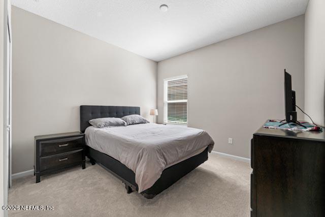 547 Tynes Boulevard Middleburg, FL 32068 - Photo 11 of 33 a bedroom with a bed and a fireplace