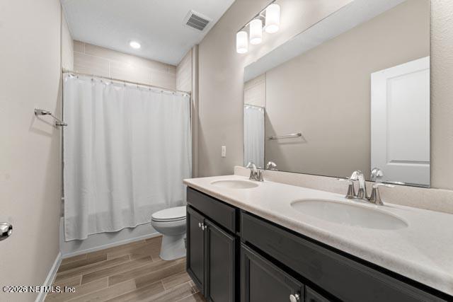 547 Tynes Boulevard Middleburg, FL 32068 - Photo 12 of 33 a bathroom with a double vanity sink toilet and a mirror