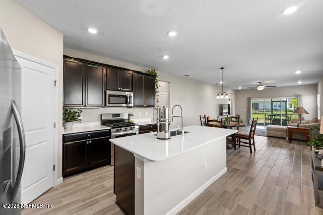 547 Tynes Boulevard Middleburg, FL 32068 - Photo 15 of 33 a kitchen with a sink a counter top space stainless steel appliances and cabinets
