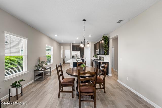 547 Tynes Boulevard Middleburg, FL 32068 - Photo 16 of 33 a view of a dining room with furniture and wooden floor