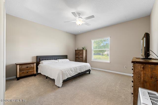 547 Tynes Boulevard Middleburg, FL 32068 - Photo 19 of 33 a bed room with a bed and a chandelier