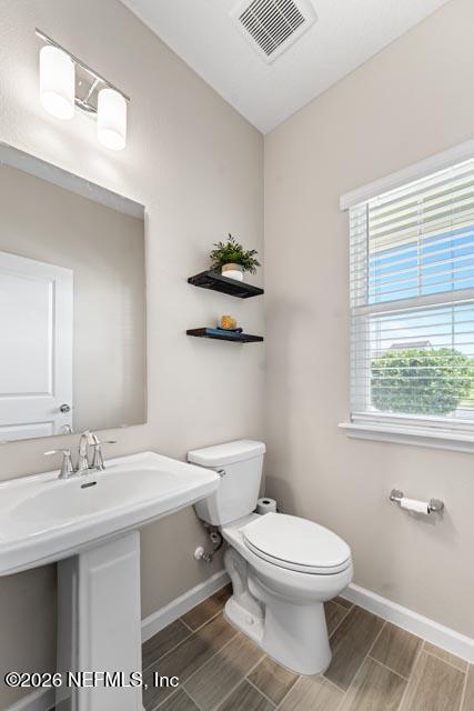 547 Tynes Boulevard Middleburg, FL 32068 - Photo 8 of 33 a bathroom with a toilet sink and mirror
