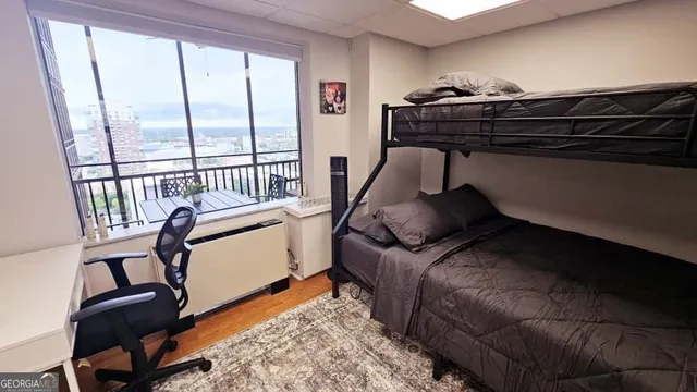 a bedroom with furniture and a window