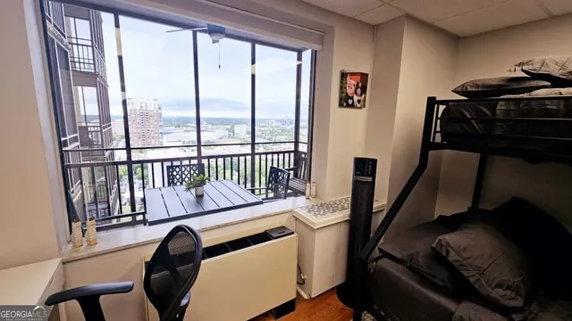 a view of a livingroom with furniture window and a flat screen tv
