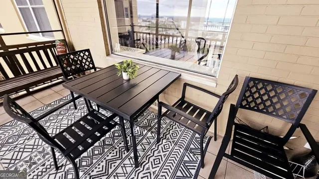 a view of a chairs and table in the balcony