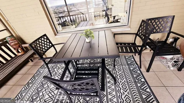a view of a chairs and table in the balcony