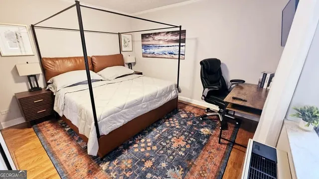 a bed sitting in a bedroom next to a window