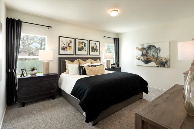 a bedroom with a bed and a painting on the wall