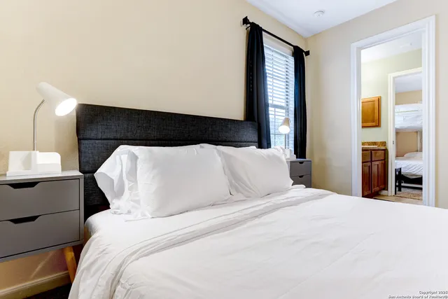 a bed room with a bed and a night stand