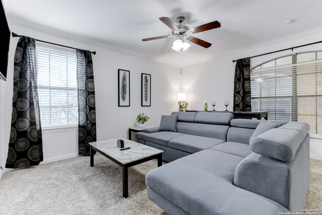 a living room with furniture and a large window