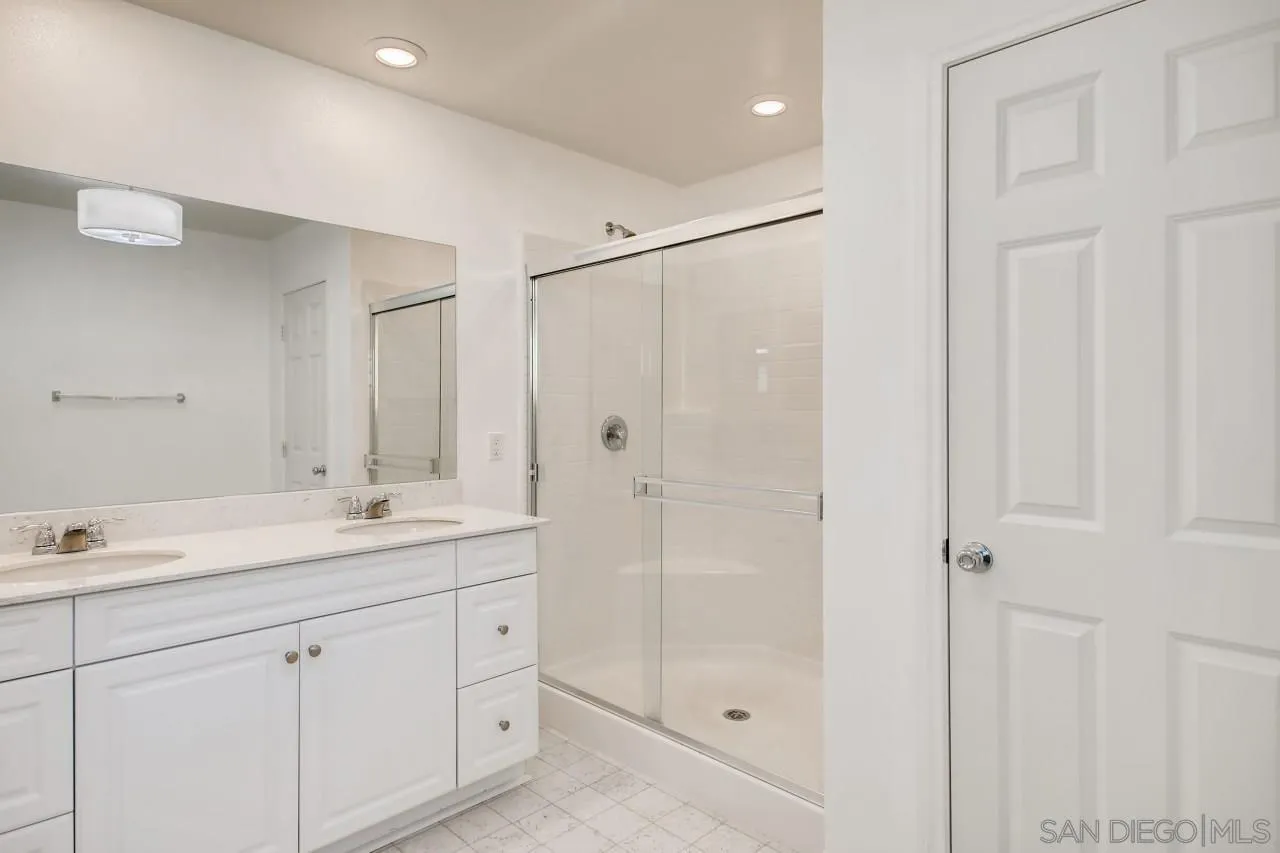 10633 Busch Street Spring Valley, CA 91978 - Photo 19 of 28 a spacious bathroom with a shower sink and mirror