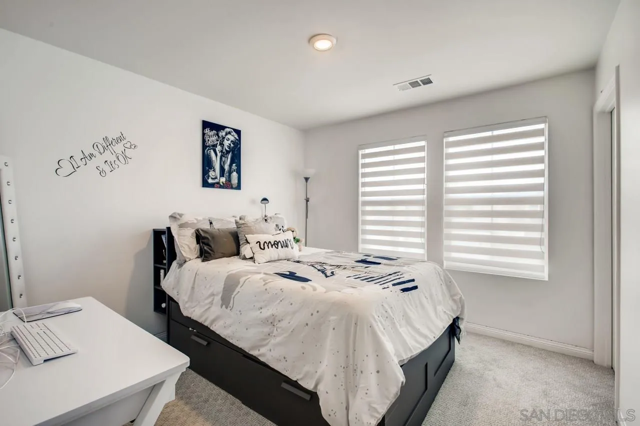 10633 Busch Street Spring Valley, CA 91978 - Photo 21 of 28 a bedroom with bed and a window