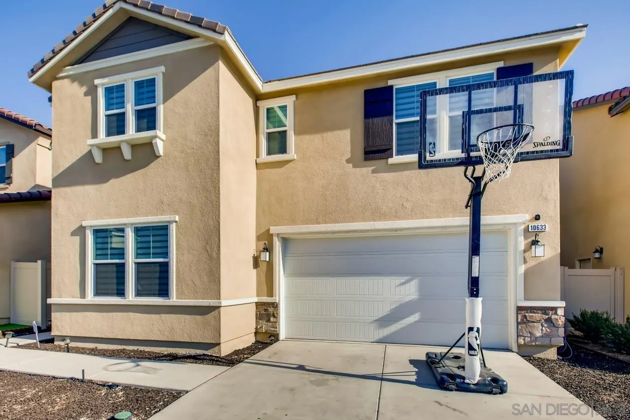 10633 Busch Street Spring Valley, CA 91978 - Photo 3 of 28 a front view of a house with a yard