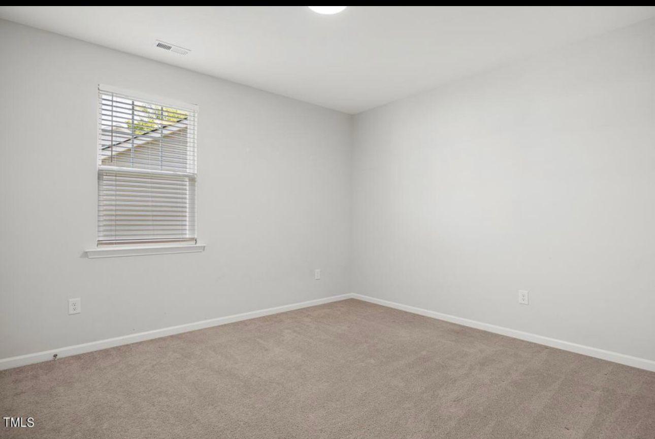154 Attavar Way Garner, NC 27529 - Photo 15 of 22 a view of an empty room with a window