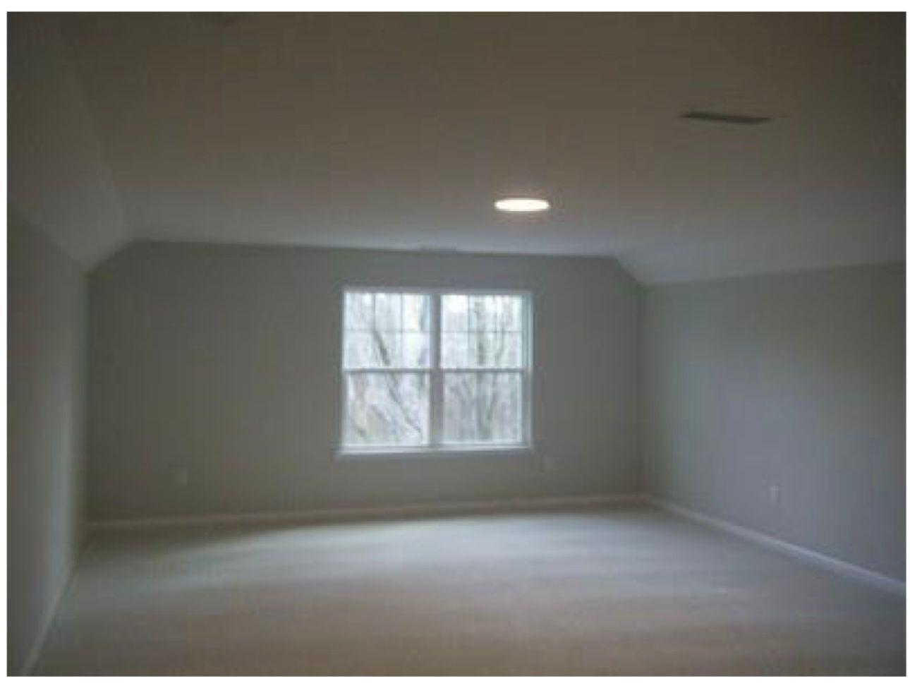 154 Attavar Way Garner, NC 27529 - Photo 16 of 22 an empty room with wooden floor and windows