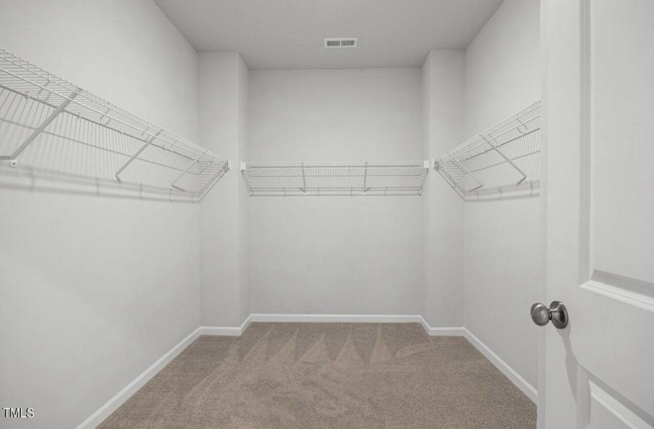 154 Attavar Way Garner, NC 27529 - Photo 18 of 22 a view of a room with racks on the wall