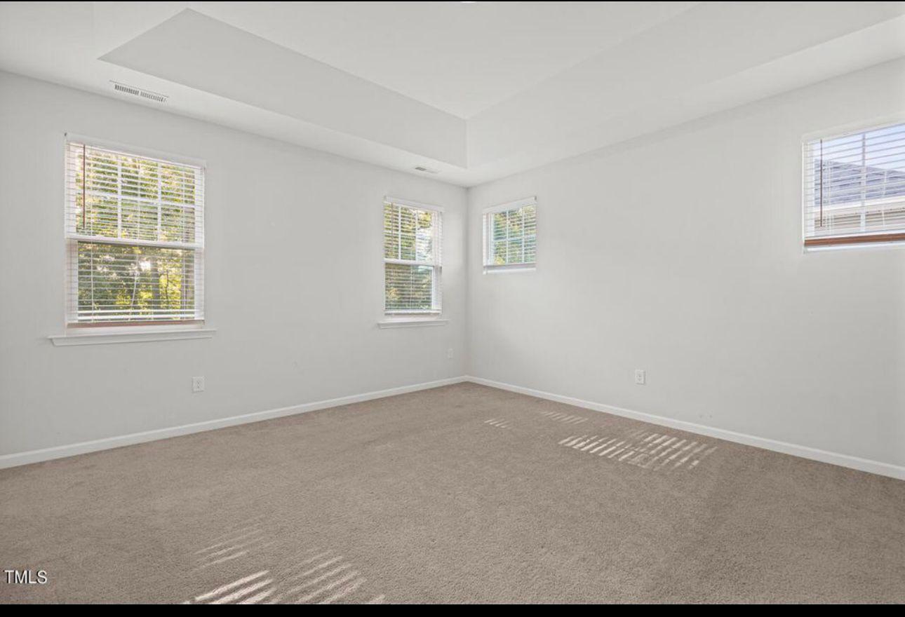 154 Attavar Way Garner, NC 27529 - Photo 21 of 22 an empty room with windows