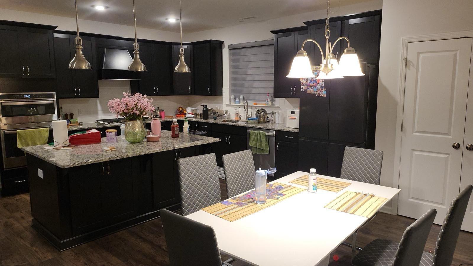 154 Attavar Way Garner, NC 27529 - Photo 5 of 22 a kitchen with a sink a cabinets and chairs