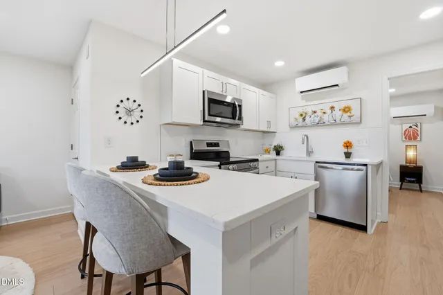 a kitchen with a stove a sink and a refrigerator