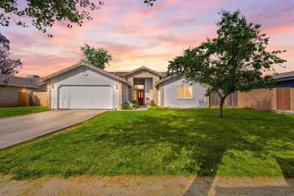 a front view of a house with a garden
