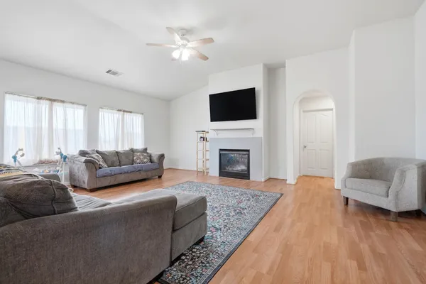 a living room with furniture a fireplace and a flat screen tv