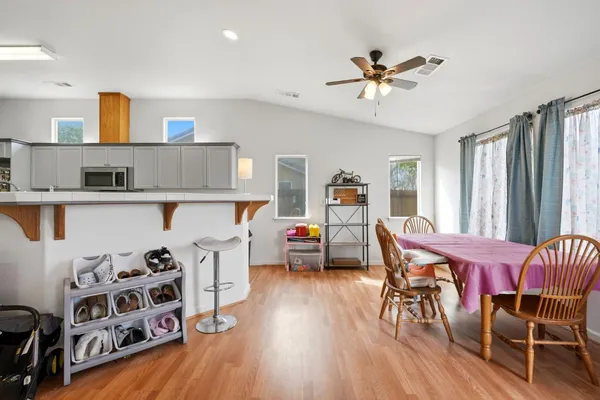 a view of a dining room with furniture and wooden floor