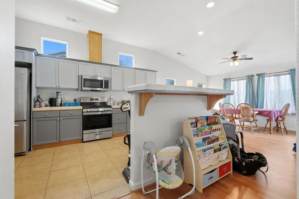 a kitchen that has a lot of cabinets a sink and appliances in it