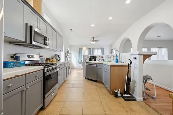 a kitchen with stainless steel appliances granite countertop a sink and cabinets