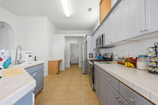 a kitchen with a sink a stove and cabinets