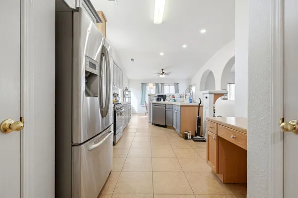 a kitchen with stainless steel appliances granite countertop a refrigerator and a sink