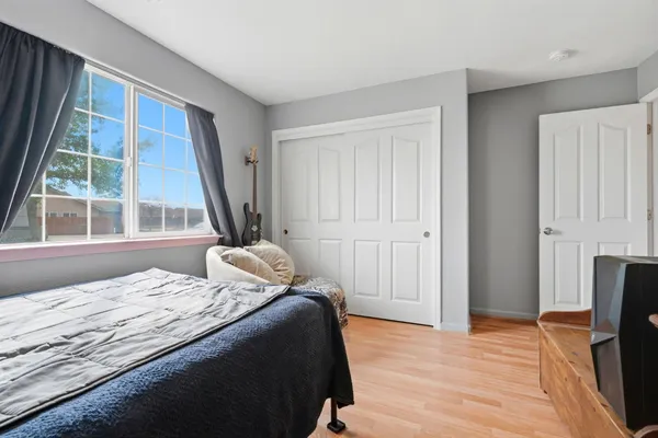 a bedroom with a bed and a flat tv screen