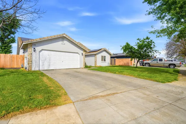 a front view of a house with a yard and garage
