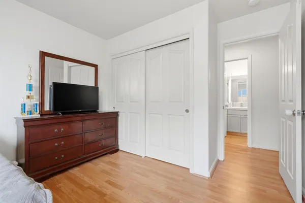 a room with a bed and a television