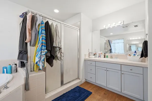 a view of walk in closet with clothes and shoes