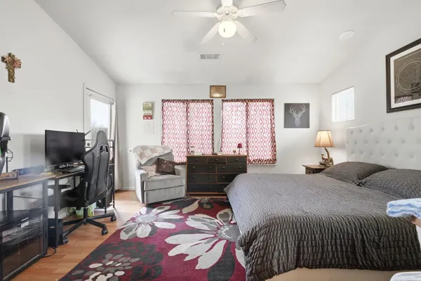 a bedroom with a bed and wooden floor