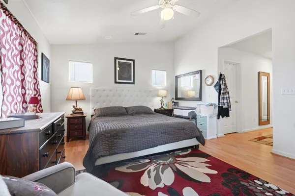 a bedroom with a bed and a chandelier