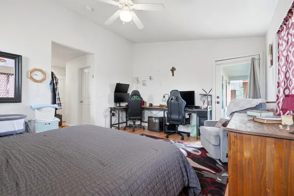 a bedroom with bed a table and chair