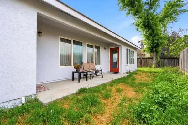 a view of house with backyard and outdoor seating