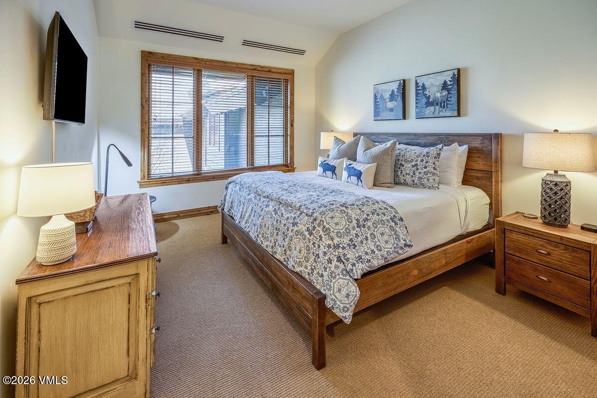 300 Prater Road, Unit A408 Beaver Creek, CO 81620 - Photo 12 of 31 a bed room with a bed and a flat tv screen on dresser