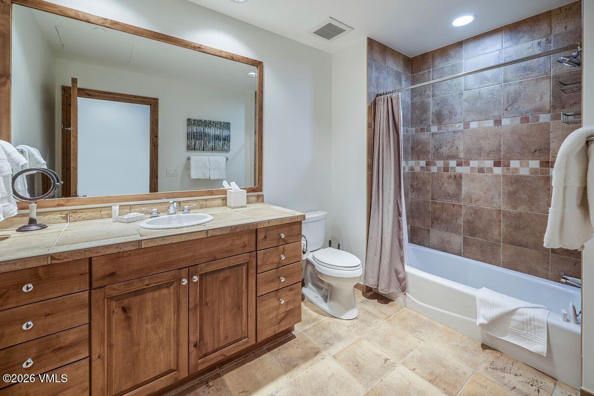 300 Prater Road, Unit A408 Beaver Creek, CO 81620 - Photo 14 of 31 a bathroom with a granite countertop sink toilet and shower