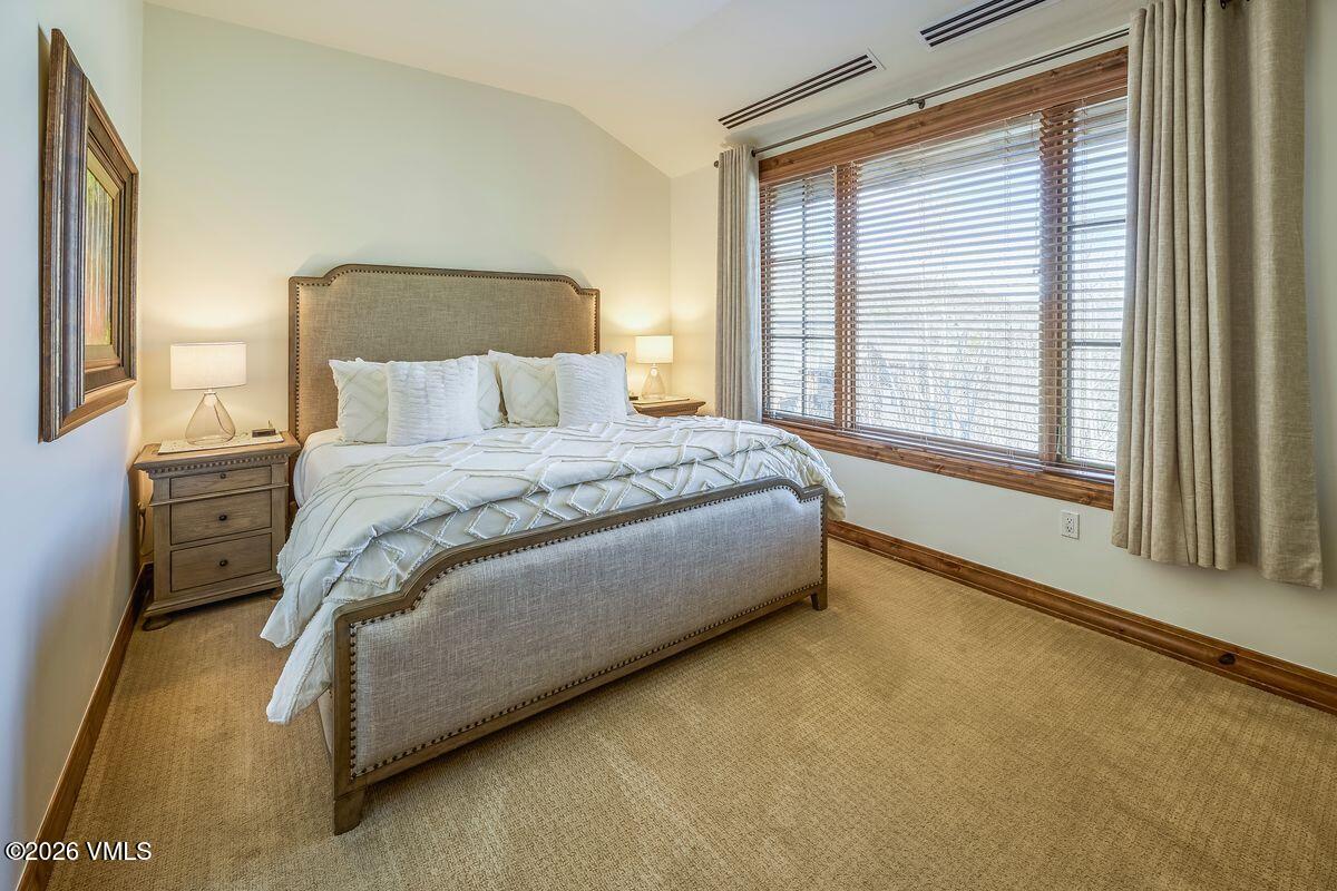300 Prater Road, Unit A408 Beaver Creek, CO 81620 - Photo 15 of 31 a spacious bedroom with a bed and a large window