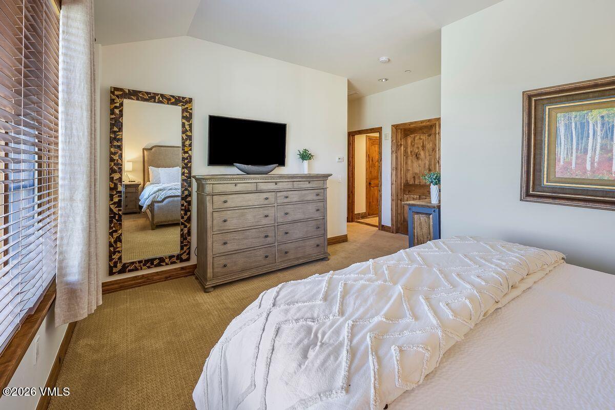 300 Prater Road, Unit A408 Beaver Creek, CO 81620 - Photo 16 of 31 a bedroom with a bed and a flat screen tv