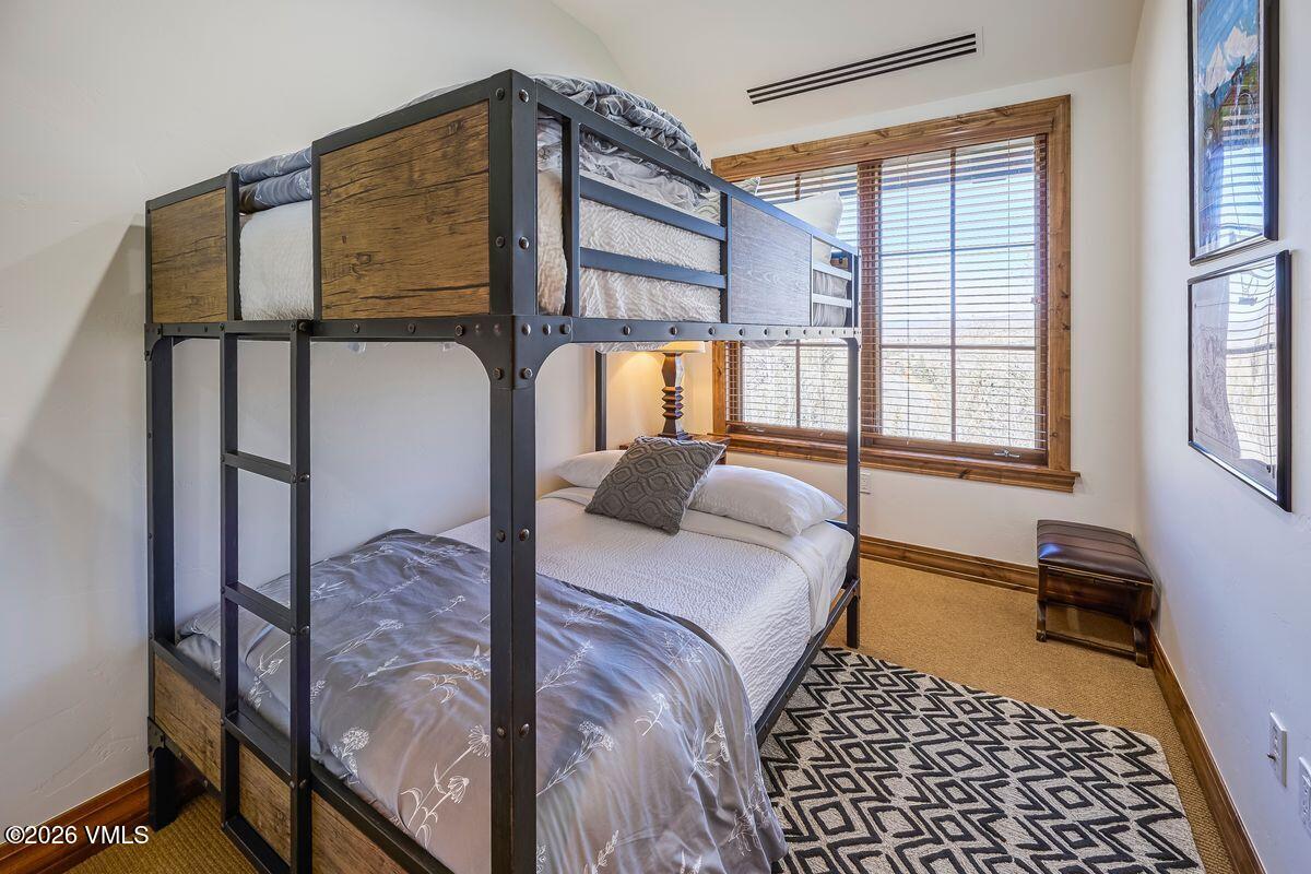 300 Prater Road, Unit A408 Beaver Creek, CO 81620 - Photo 19 of 31 a bedroom with a bed and wooden floor